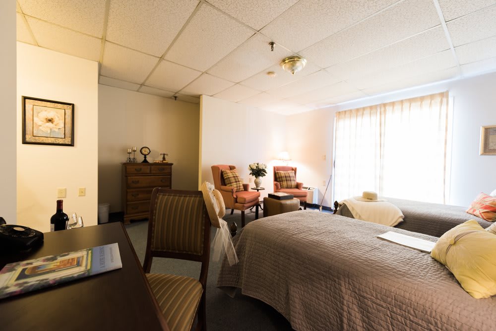 A cozy bedroom with comfortable furnishings and ample natural light.