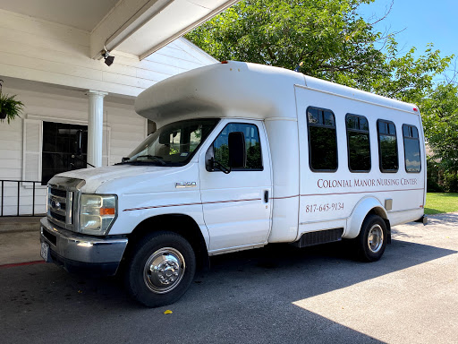 A white shuttle bus parked in a lot, ready for transport.