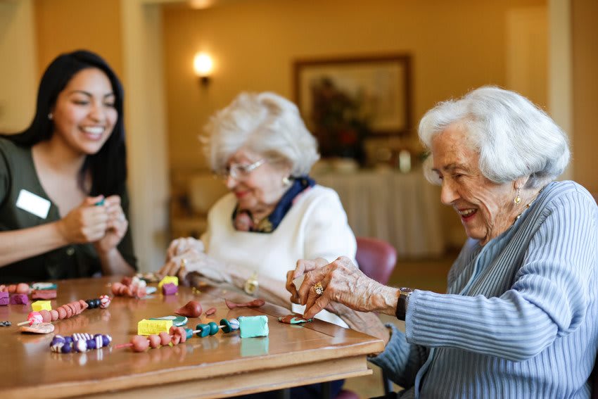 Seniors engaging in a joyful crafting activity together.