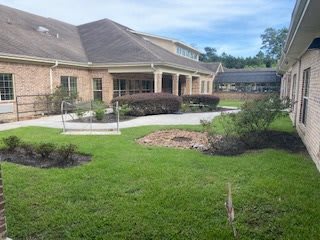 A house with a well-maintained garden and lawn.