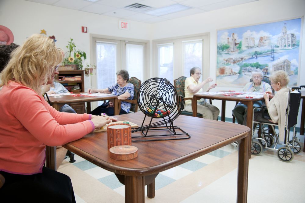 A group of seniors playing bingo in a recreational room.