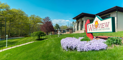 A beautiful spring day showcasing the vibrant flowers and modern architecture of a welcoming building.