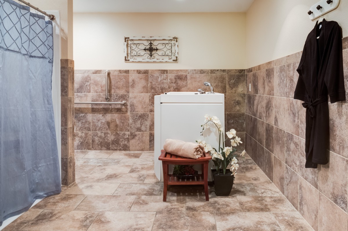 A well-organized laundry room with a washer and tasteful decor.
