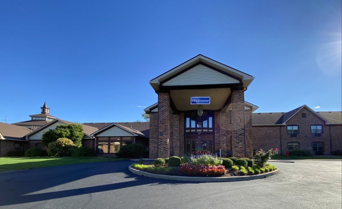 A church building with a prominent entrance under a clear blue sky.