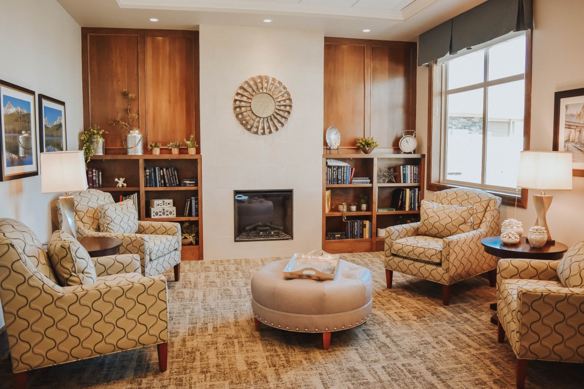 Cozy living room with comfortable seating and a central fireplace.