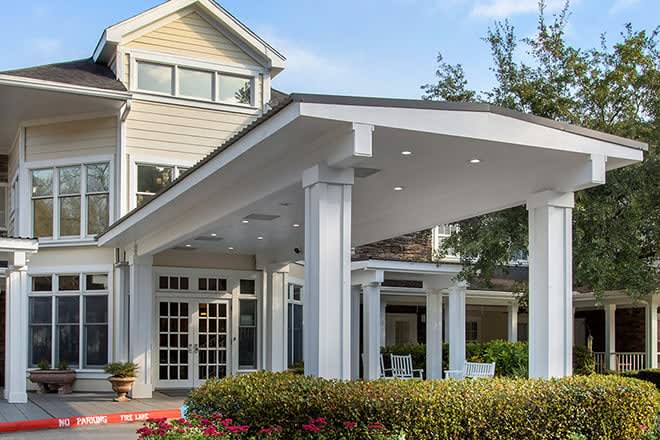 A beautiful residential house with a spacious porch and classic architectural features.