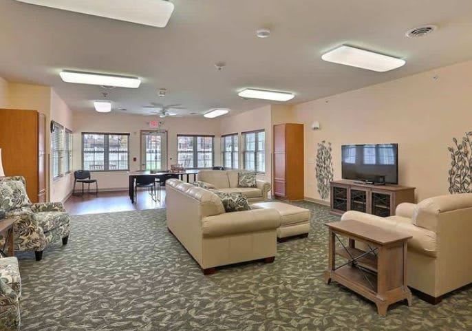 A spacious living room with modern furniture and large windows.