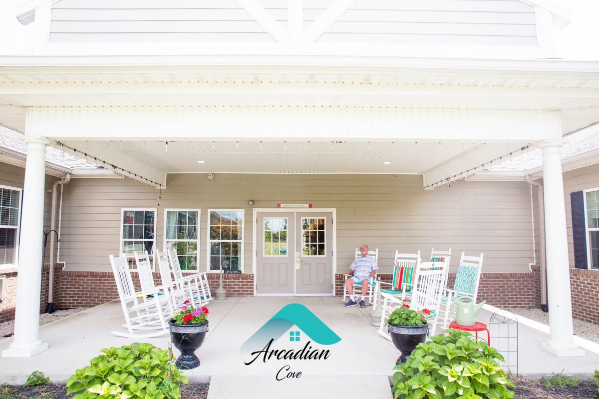 A welcoming front porch with rocking chairs and potted plants at the entrance.