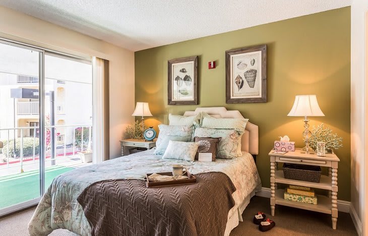 A cozy bedroom with elegant decor, featuring a neatly made bed and warm lighting.
