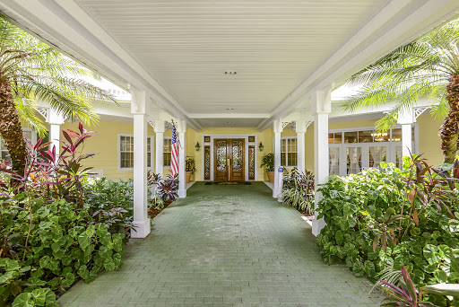 A welcoming entrance with lush greenery and elegant columns.
