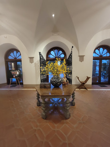 A beautifully designed interior space featuring a decorative table with flowers, framed by elegant windows.