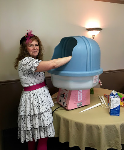 A joyful moment at a celebration with a cotton candy machine.