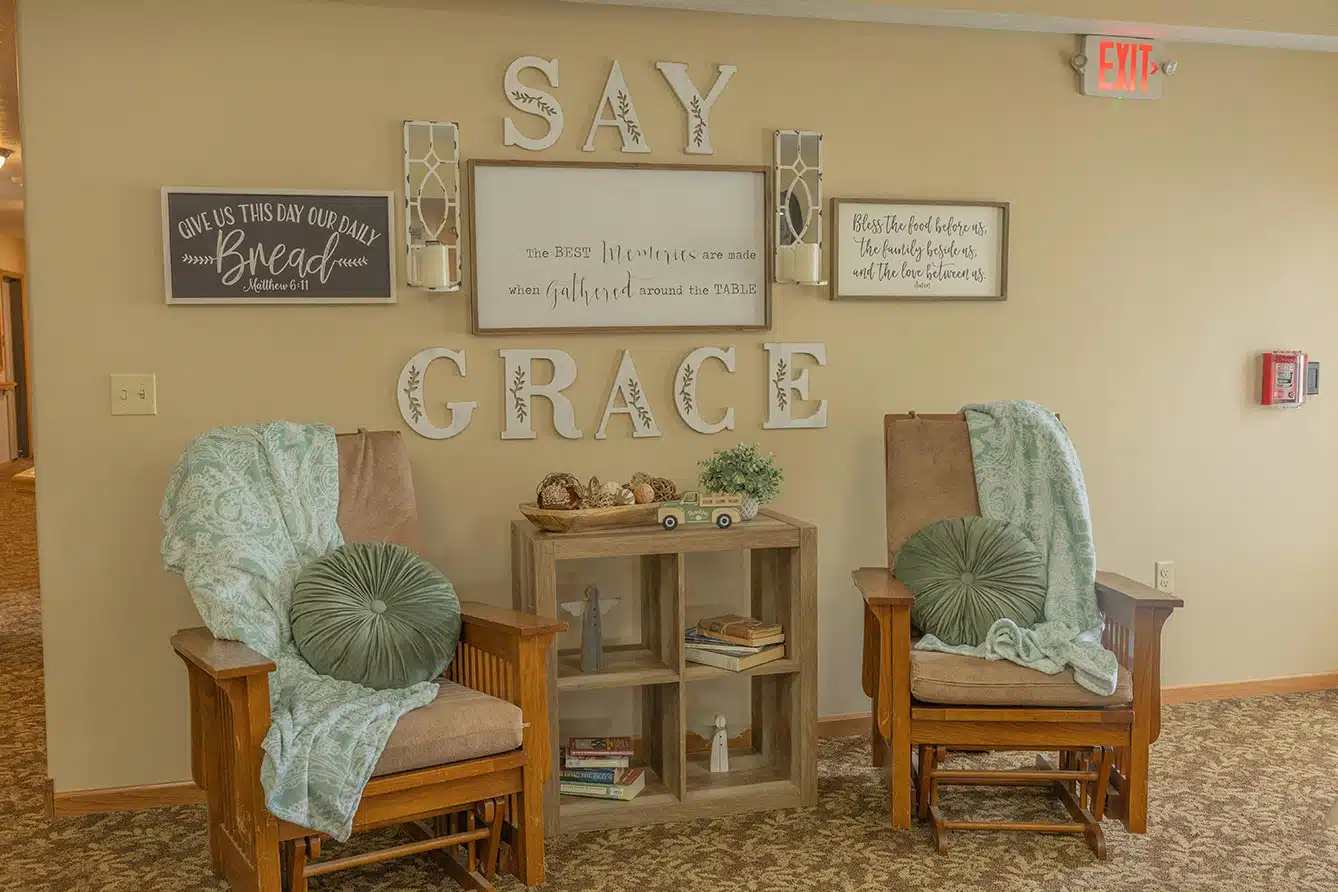A cozy seating area with decorative signs encouraging reflection and comfort.