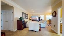 A cozy living room with comfortable seating and a large television.