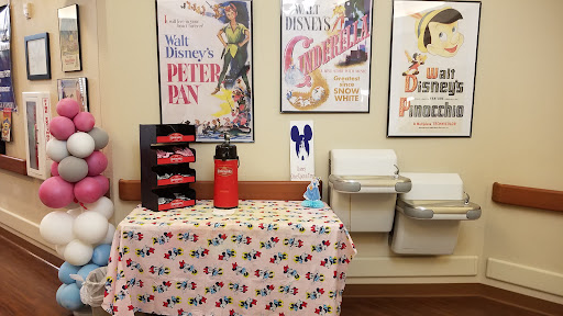 A charming display featuring classic Disney movie posters of 'Peter Pan' and 'Cinderella', with a decorated table setup.