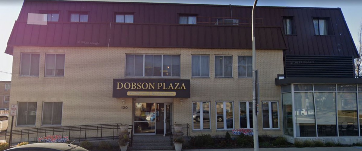 The front view of Dobson Plaza, featuring its entrance and windows.