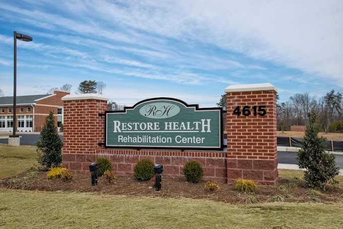 An outdoor sign for Restore Health Rehabilitation Center.