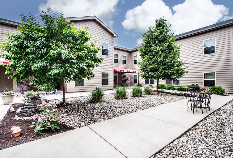 A landscaped courtyard outside a modern apartment building.