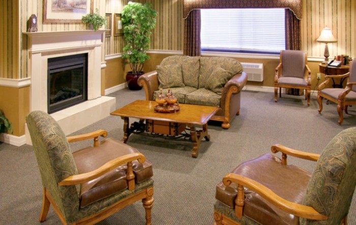 A cozy living room with classic furniture and a warm fireplace.