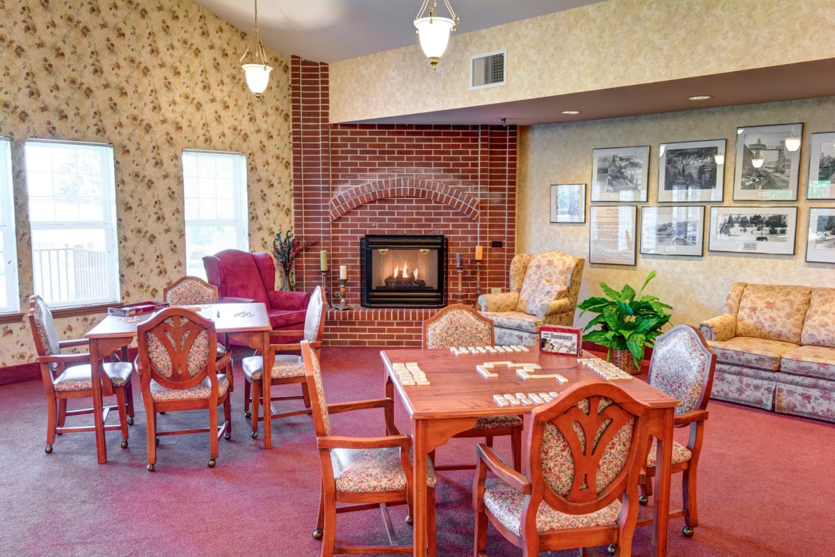 Cozy dining area with a fireplace and comfortable seating.