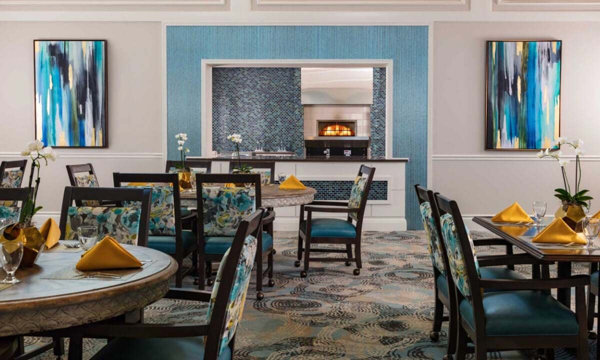 A stylish dining room with elegant blue decor and comfortable seating.