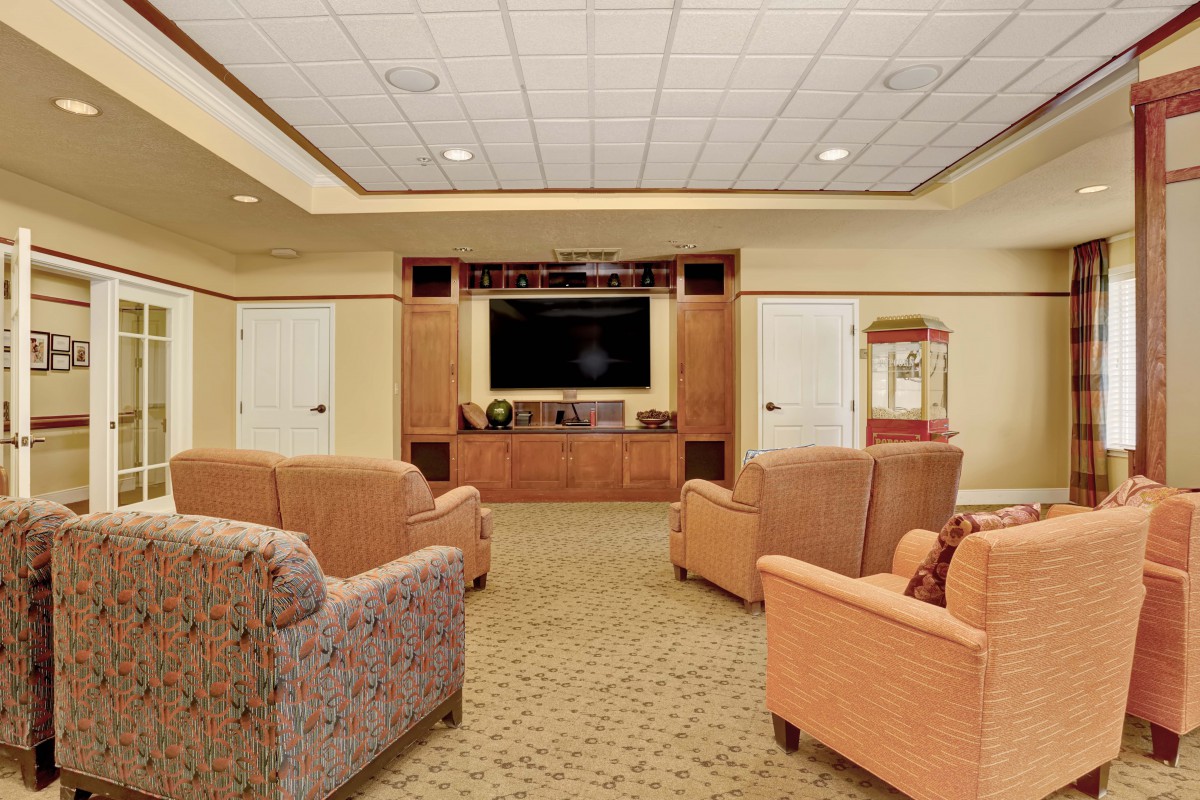 A cozy home theater setup with comfortable seating and a large television.
