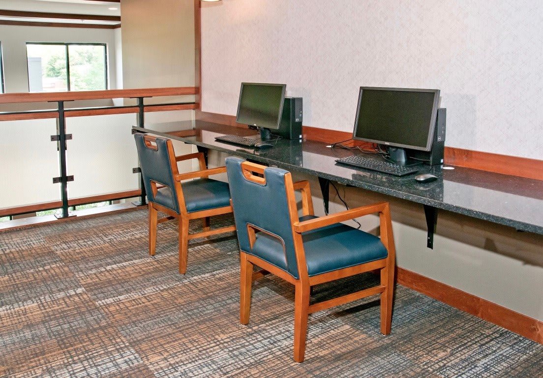 An office setup with desks and computers prepared for use.