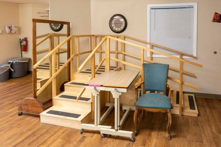 An indoor physical therapy area with stairs and equipment designed for rehabilitation exercises.