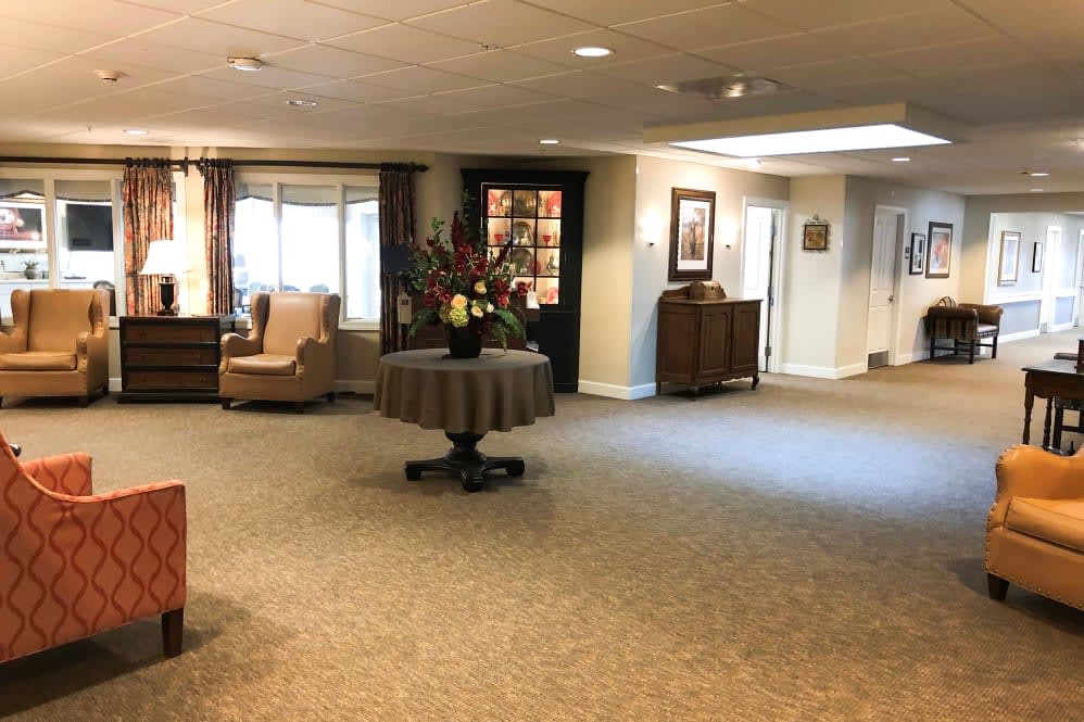 A spacious lobby area with comfortable seating and floral decorations.