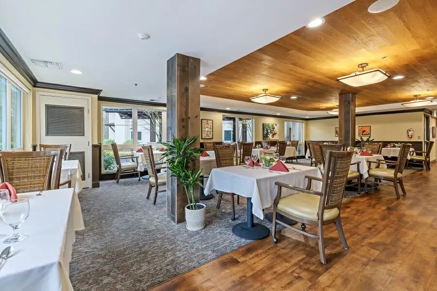 A cozy dining area with neatly arranged tables and warm lighting.