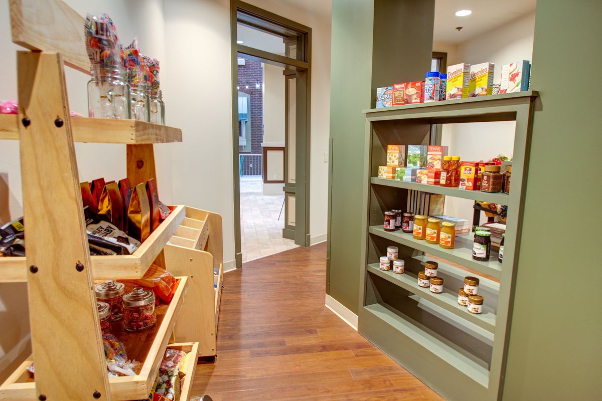 A small retail shop interior with shelves stocked with various products.