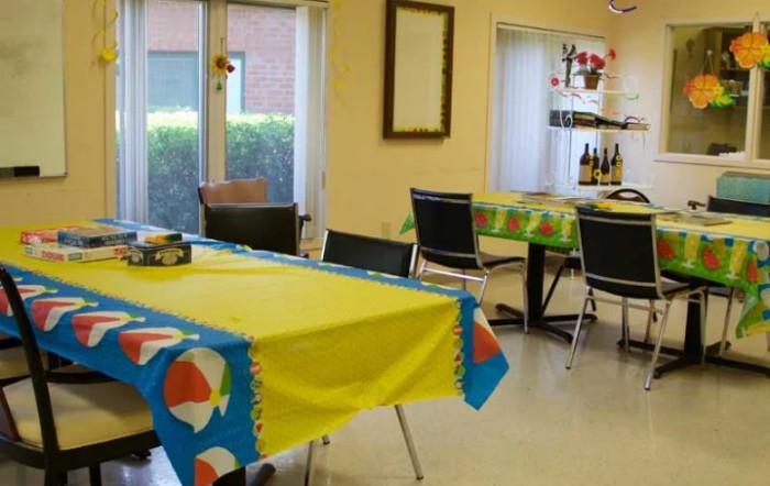 A colorful dining room with tables covered in bright tablecloths.
