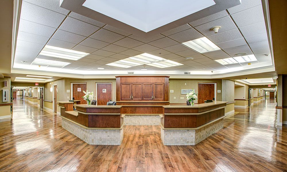 Modern reception area with wooden desk and bright lighting.