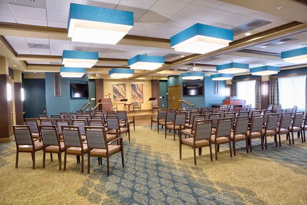A spacious conference room with arranged seating and modern lighting.