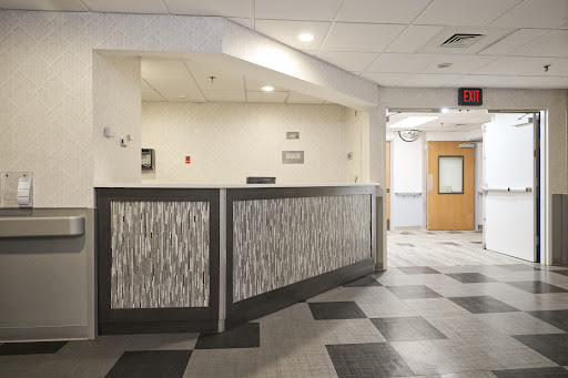 A modern reception area featuring a stylish counter and patterned flooring.