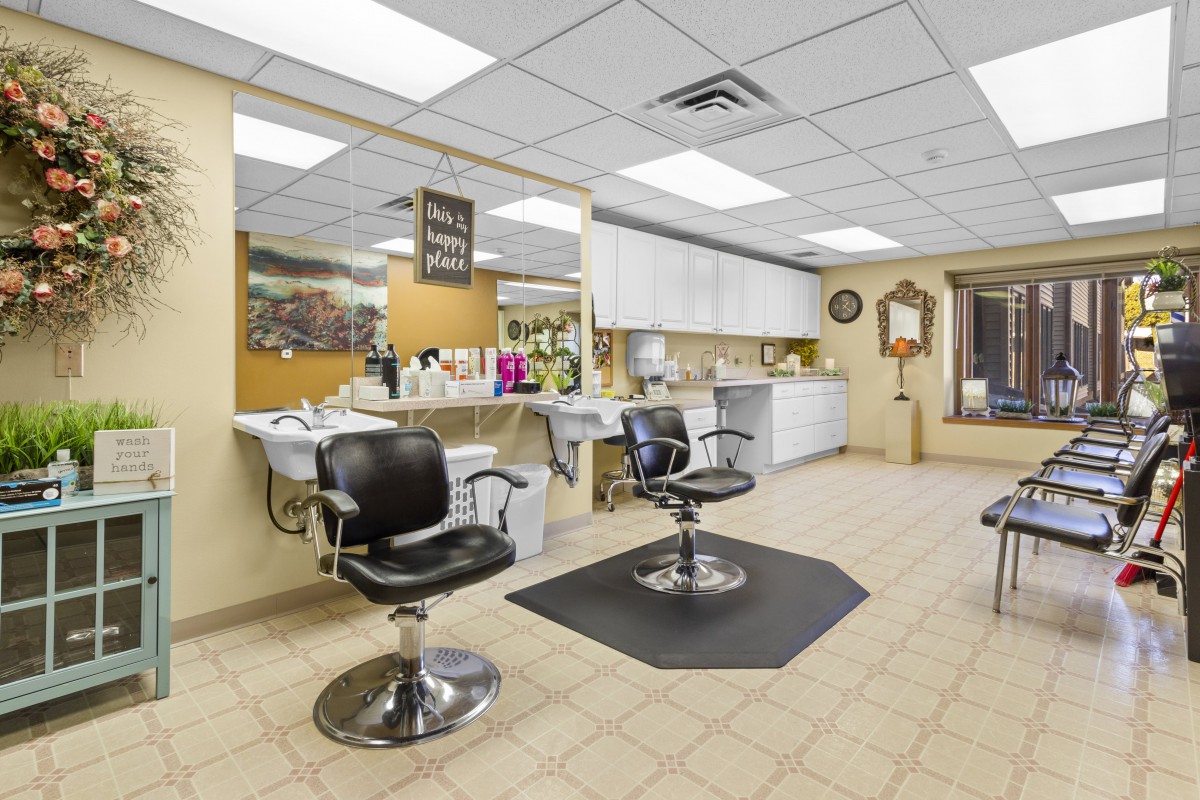 Interior of a clean and professional barbershop with styling chairs and mirrors.