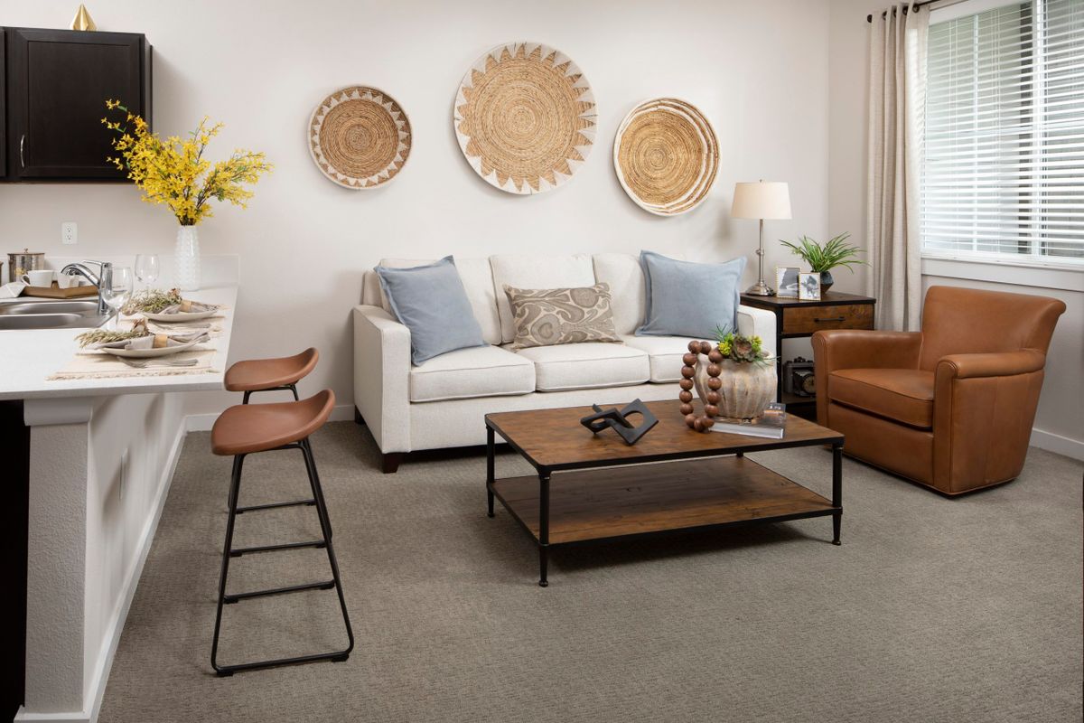 A cozy and stylish living room featuring a comfortable sofa, decorative wall art, and a modern coffee table.