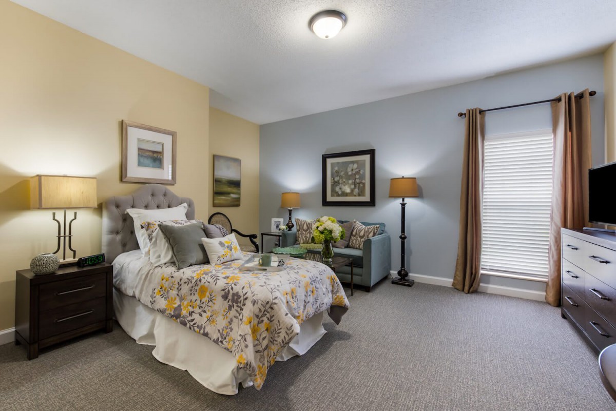 A cozy bedroom with stylish decor and a well-made bed.
