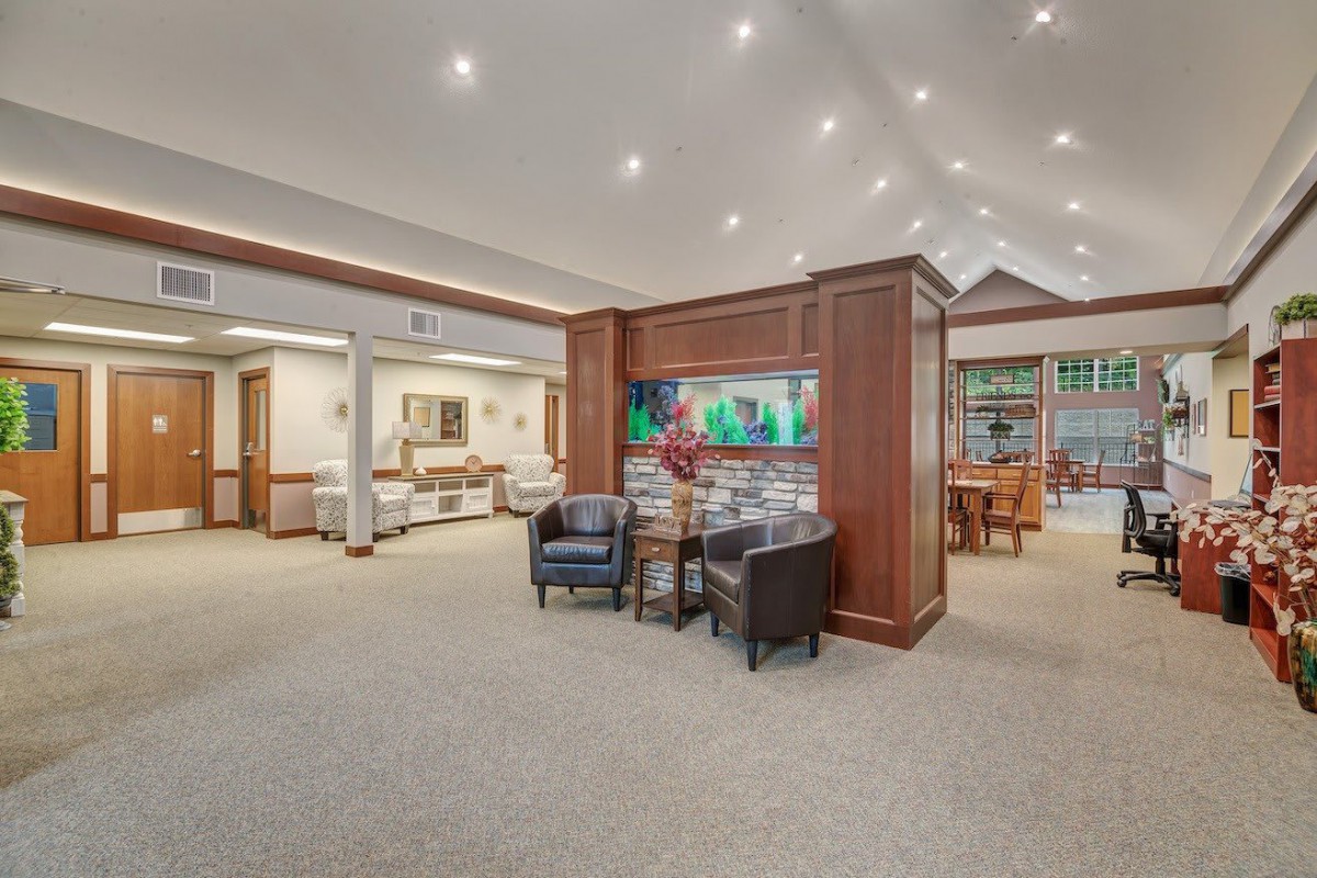 A spacious and well-lit lobby with comfortable seating and wooden accents.