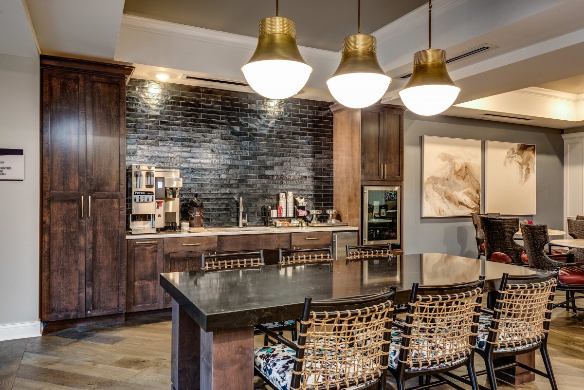 A modern kitchen interior with pendant lights and a sleek countertop.