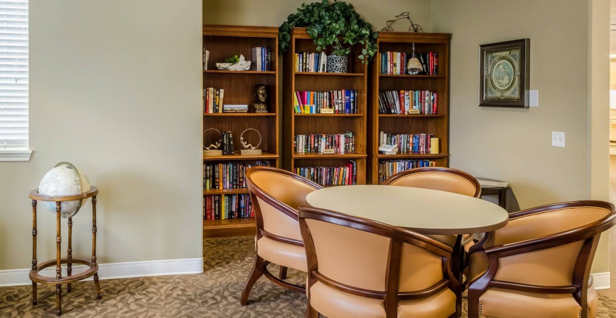 A cozy reading area with bookshelves and comfortable seating.