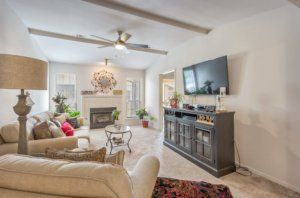 A cozy living room featuring a fireplace, television, and comfortable seating.
