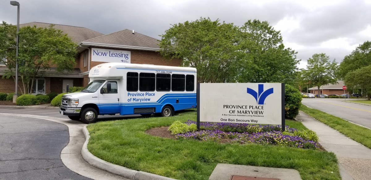 A shuttle bus parked outside Providence Place of Maryville, a healthcare facility.