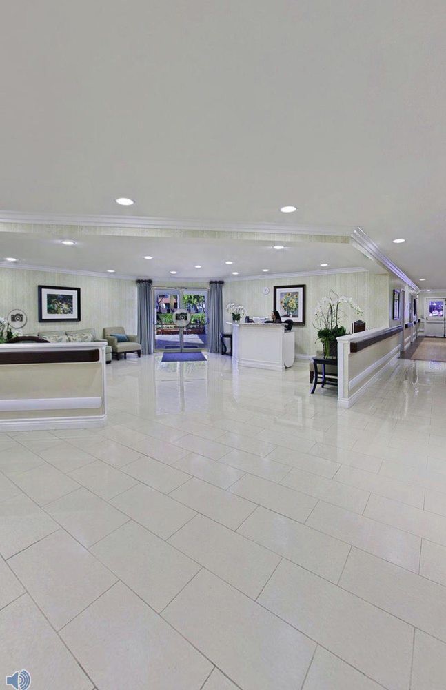 A modern reception area with desks and seating in a spacious lobby.