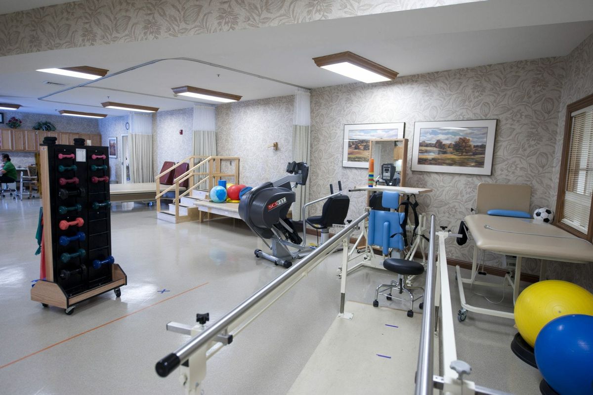 A rehabilitation room equipped with various exercise machines and tools for physical therapy.