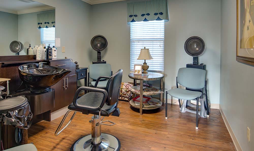 A cozy salon interior with hair styling stations and chairs.