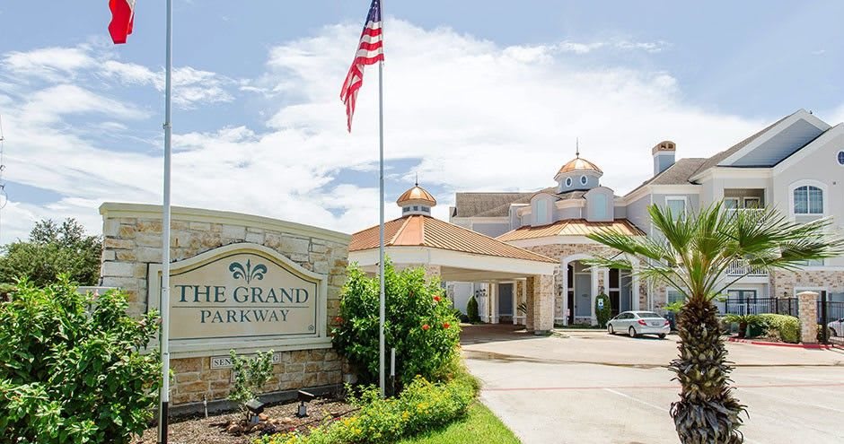 Entrance of a hotel with an American flag and a welcoming sign.