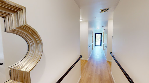 A bright, modern hallway featuring a minimalist design with decorative elements.