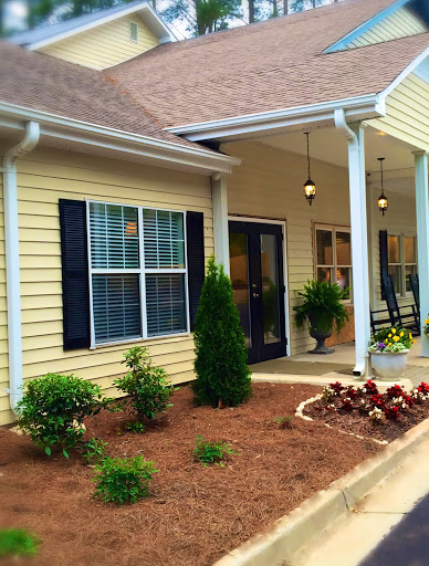 A charming house exterior with a welcoming porch and well-maintained garden.
