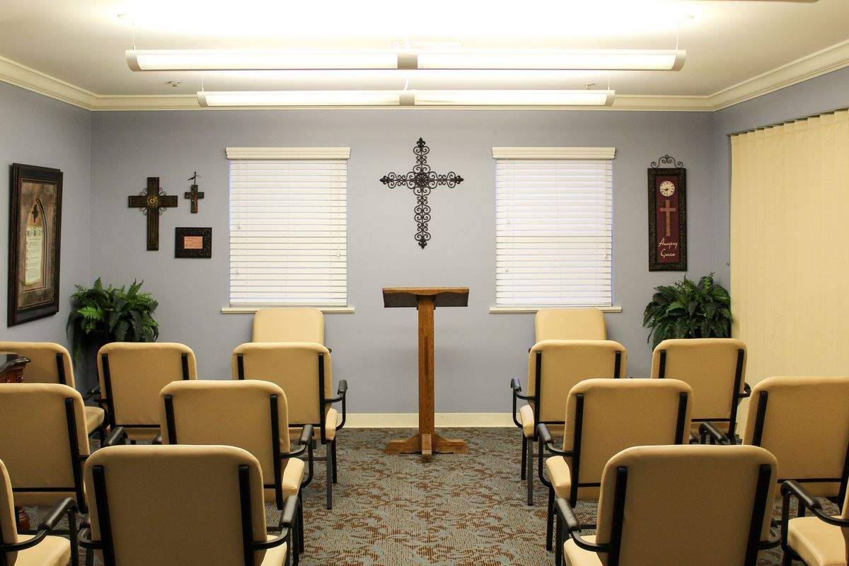 A small chapel with a podium and chairs arranged for a service.
